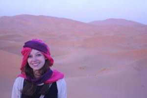 Lydia Grossman in front of a desert in Morocco.