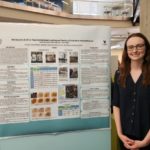 Catherine Crowell presents her research poster at the Summer Science Symposium