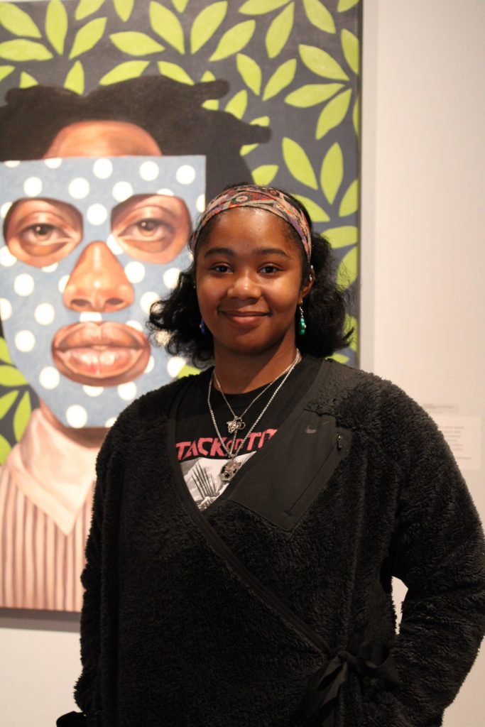 UMW student Jasmine Folson with paiting " She Sang a Song No One Would Hear" by Ronald Jackson