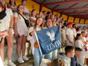 Students hold up UMW banner with watching the running of the bulls in Pamplona Spain