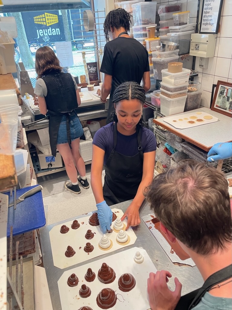 Ariana Adamek prepping food in Copenhagen with other students and locals