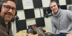 Professor and student in the recording studio with headphones and microphones
