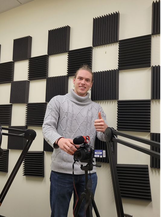 Wiley Prior holding a camera in the recording studio