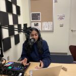 Rebecca Cherian with equipment in the recording studio to record her podcast Concilience