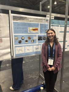 Ainsley Lord stands in front of her poster