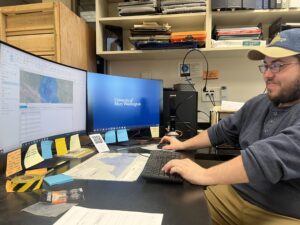 Student works at the computer in the archeology lab