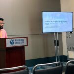 student gives oral presentation at the podium