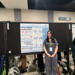 student presents poster