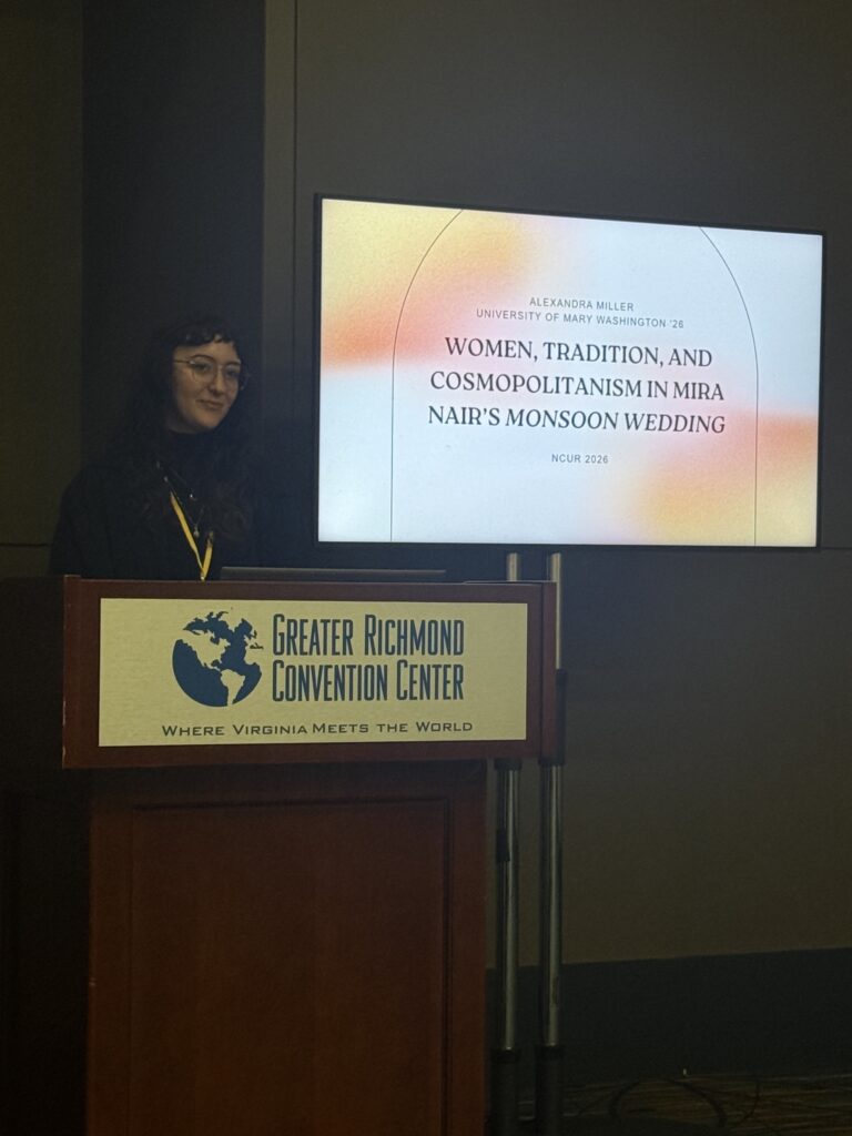 Ally Miller presents at NCUR from the podium with a title slide in the background.