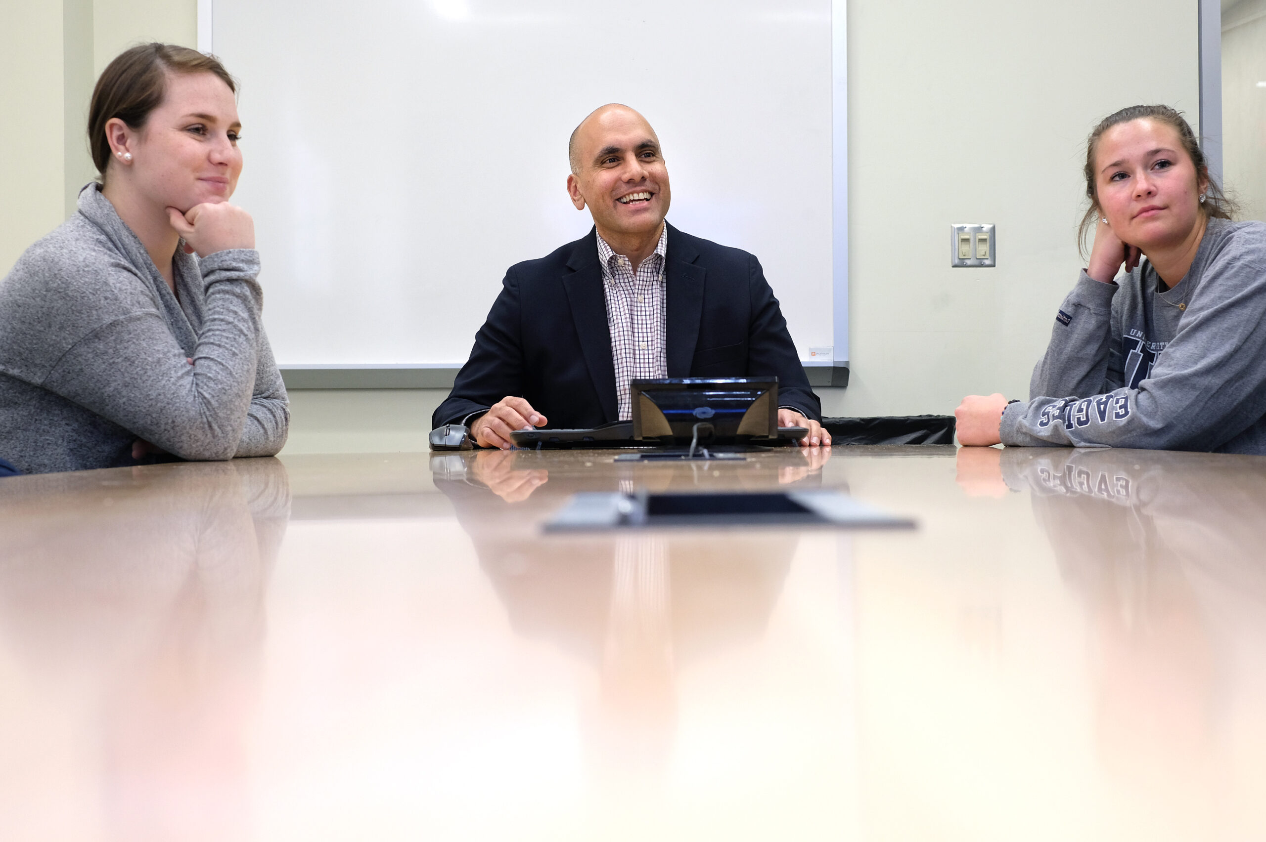 Photo of Anand Rao talking with students