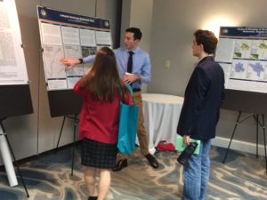 Matthew Lehane explains his poster to an audience.