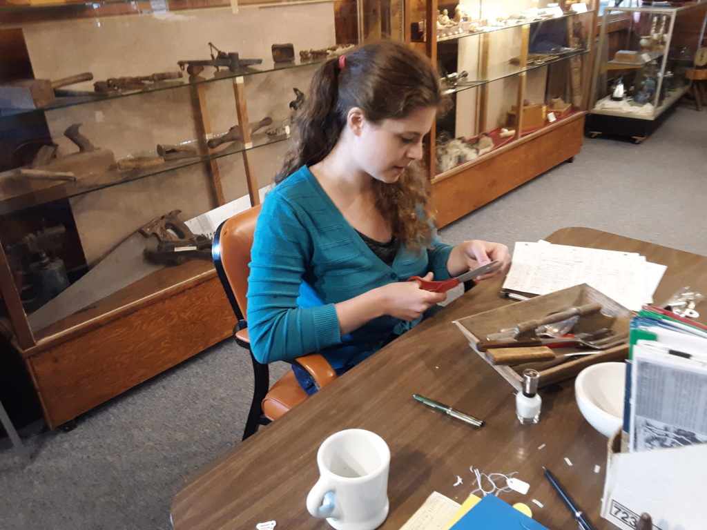Student Abigail Phelps working with artifact collection