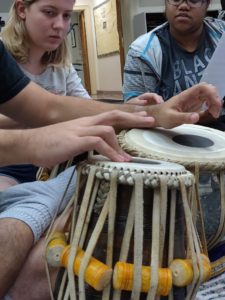 Two UMW students in the Indian Music Ensemble in a tabla masterclass with a guest artist