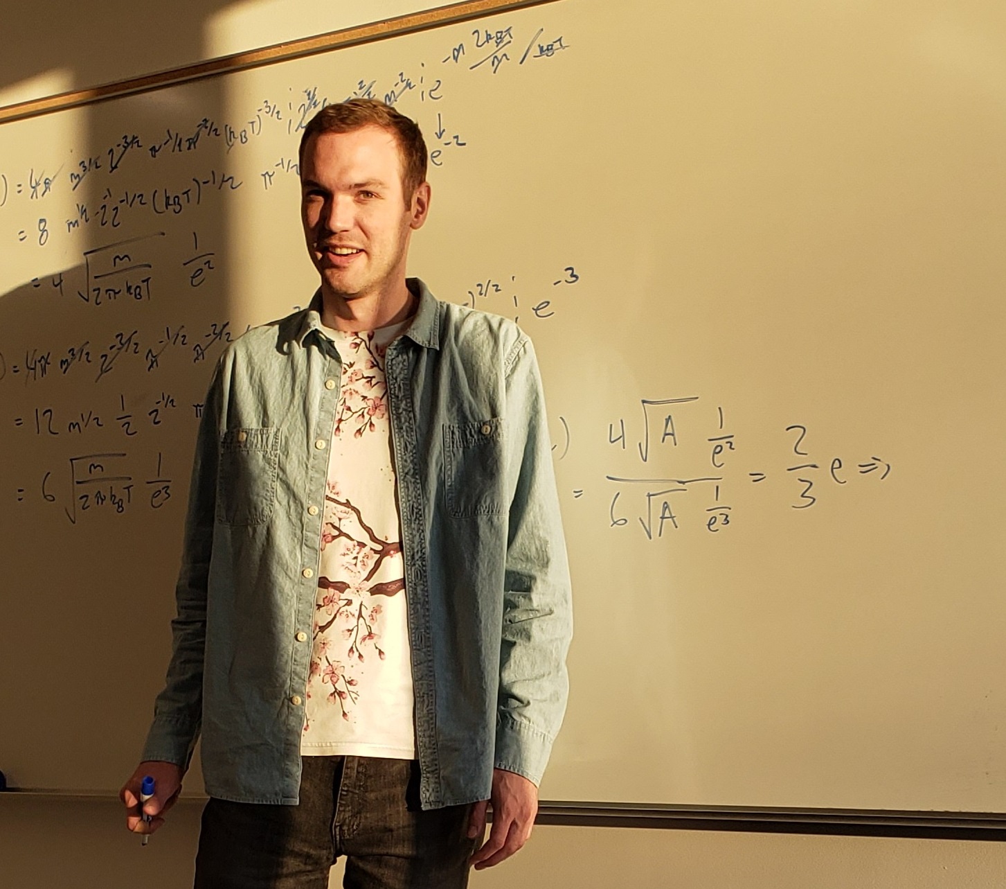 Image of Henry Mills at a whiteboard with equations