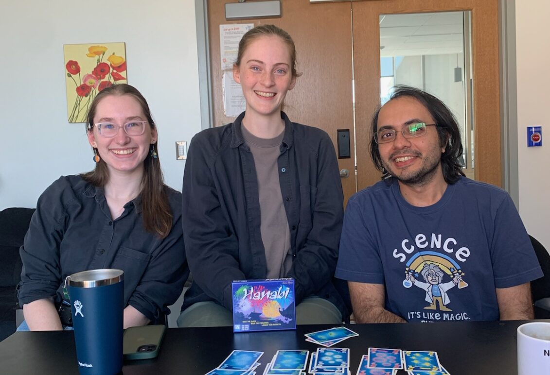 Professor Makhija and students play a card game.