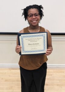 Maya Jenkins holding her award.