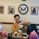 Morgan in an office saying Department of State showing her Chinese gongfu tea set while pouring some tea.