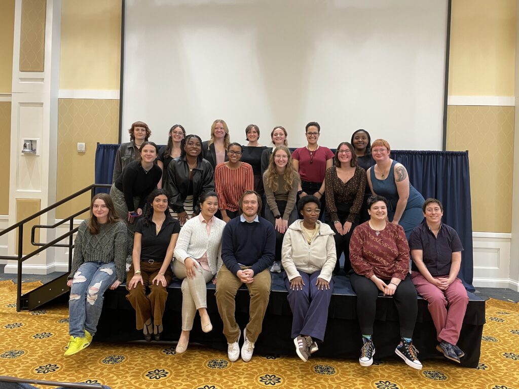 A group of students posing for a photo on a stage. 